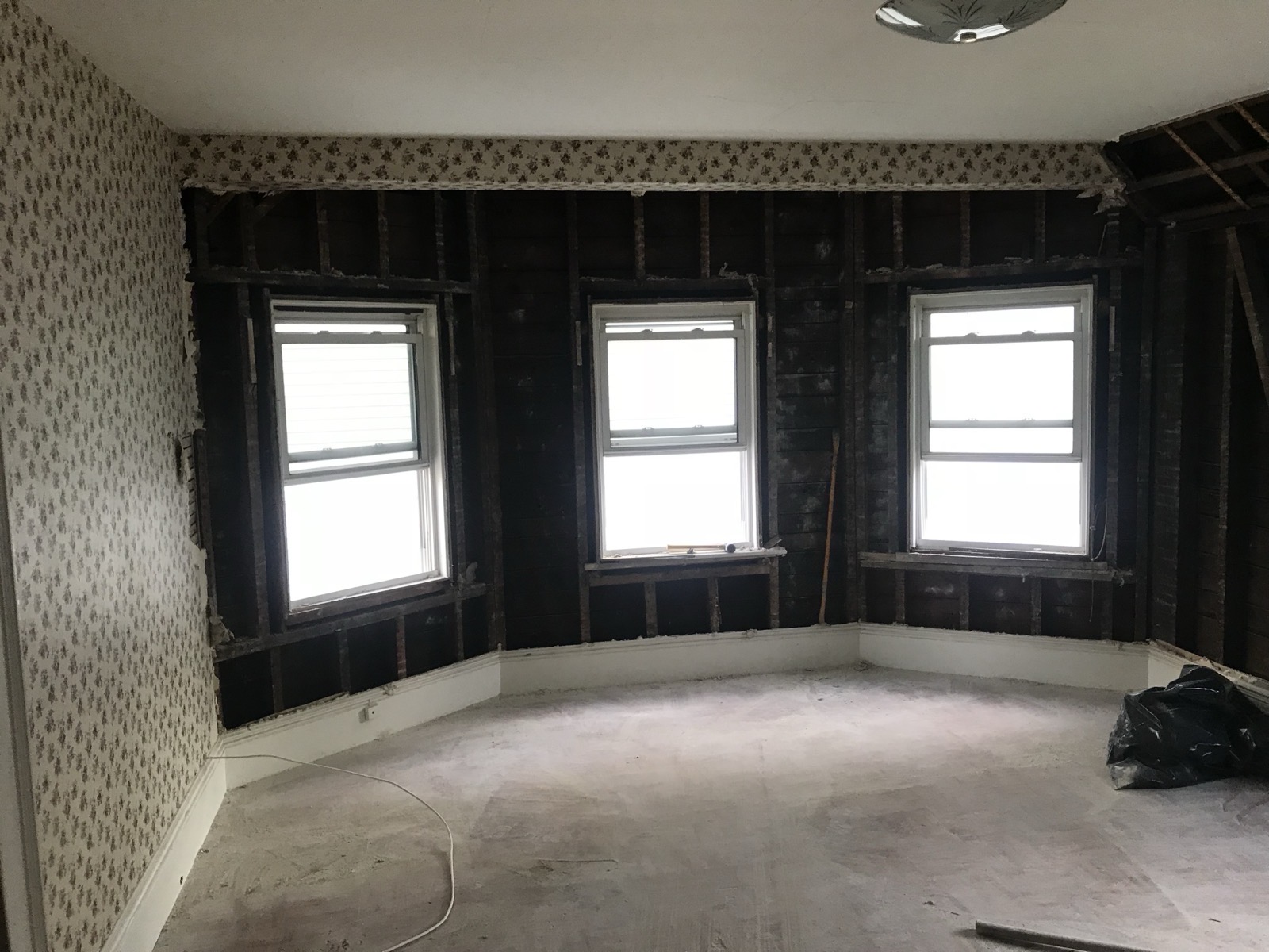 Bedroom stripped to studs after wallpaper and plaster removal